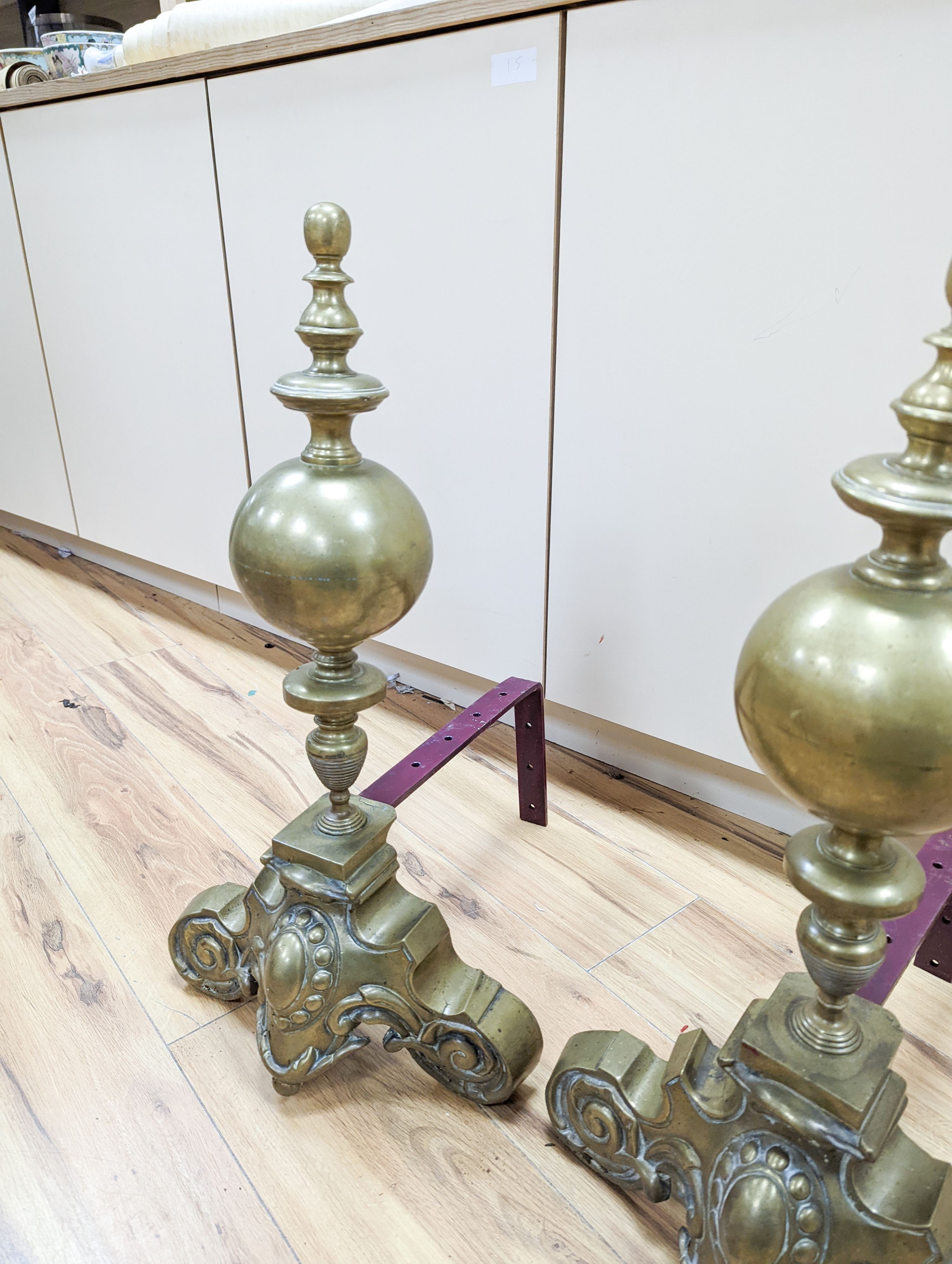 A pair of brass and iron fire dogs 62cm